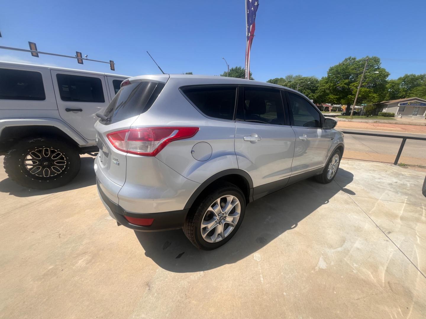 2013 BLACK FORD ESCAPE SEL SEL 4WD (1FMCU9H98DU) with an 2.0L L4 DOHC 16V engine, 6-Speed Automatic transmission, located at 8101 E. Skelly Dr., Tulsa, OK, 74129, (918) 592-3593, 36.121891, -95.888802 - Photo#4